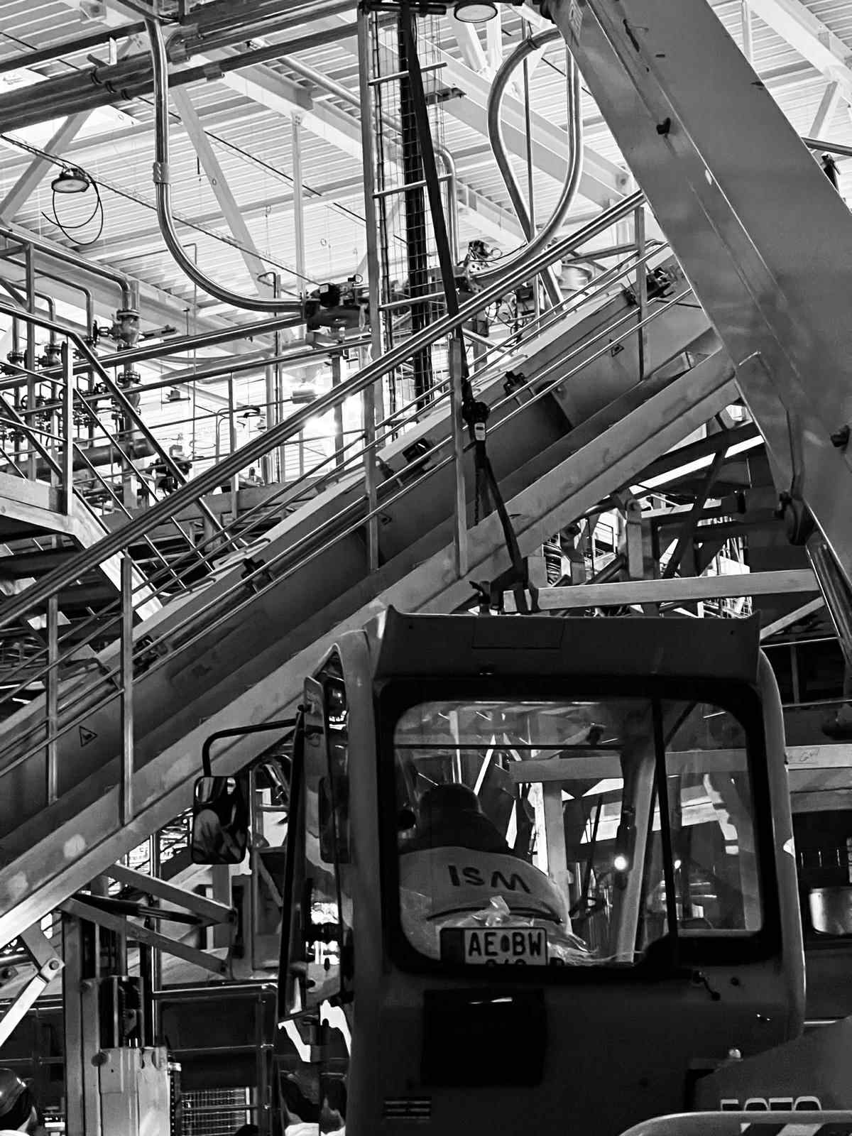 Conveyor belt and stairs of a steel structure in a factory hall