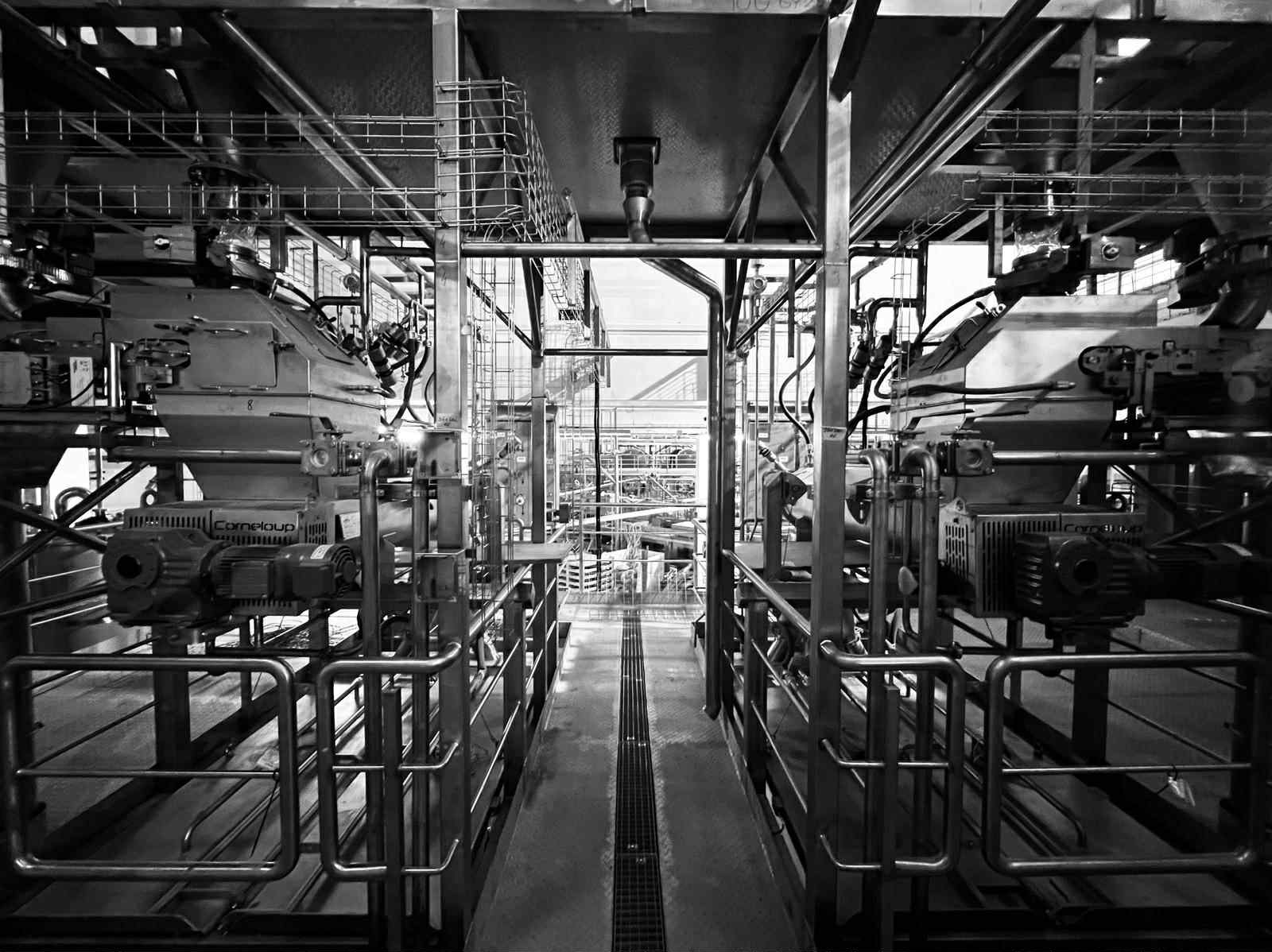 Two machine lines with drives and cable trays in a production hall